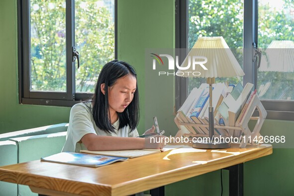 Students are reading in a green lacquered ''train book house'' in Yuping county, Guizhou province, China, on July 21, 2024. 