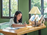 Students are reading in a green lacquered ''train book house'' in Yuping county, Guizhou province, China, on July 21, 2024. (