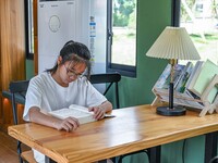 Students are reading in a green lacquered ''train book house'' in Yuping county, Guizhou province, China, on July 21, 2024. (