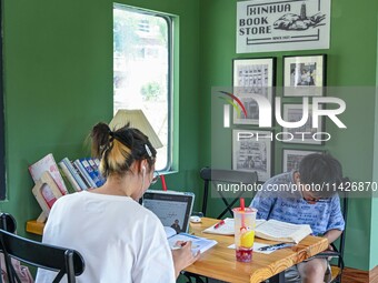 Students are reading in a green lacquered ''train book house'' in Yuping county, Guizhou province, China, on July 21, 2024. (