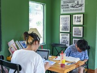 Students are reading in a green lacquered ''train book house'' in Yuping county, Guizhou province, China, on July 21, 2024. (