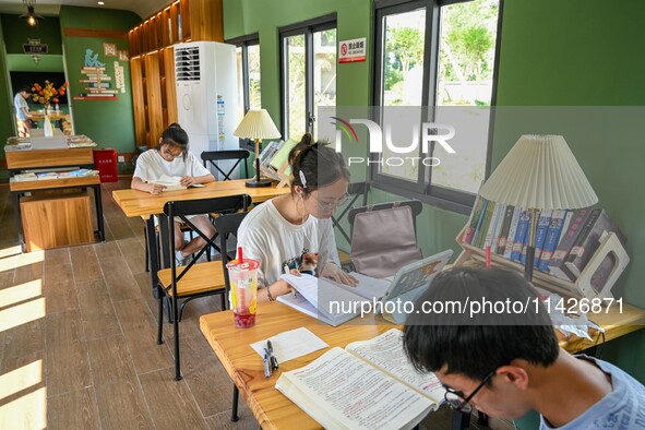 Students are reading in a green lacquered ''train book house'' in Yuping county, Guizhou province, China, on July 21, 2024. 