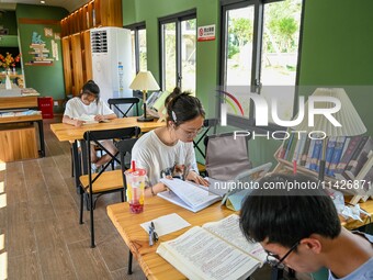 Students are reading in a green lacquered ''train book house'' in Yuping county, Guizhou province, China, on July 21, 2024. (