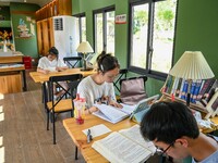 Students are reading in a green lacquered ''train book house'' in Yuping county, Guizhou province, China, on July 21, 2024. (