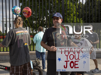 A visitor is holding a sign with the words ''Thank You Joe'' in front of the White House in Washington, DC, USA, on July 21, 2024. The day J...