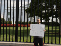 A visitor is holding a sign with the words ''Bye Joe'' in front of the White House in Washington, DC, USA, on July 21, 2024. The day Joe Bid...