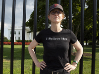 A woman is wearing a shirt with the words ''I Believe Her'' to support the Democratic Party's new nominee Kamala Harris in front of the Whit...