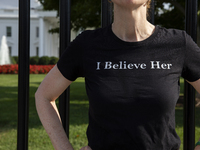 A woman is wearing a shirt with the words ''I Believe Her'' to support the Democratic Party's new nominee Kamala Harris in front of the Whit...