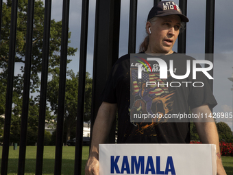 A man is wearing a shirt with the words ''Let's Go Kamala'' to support the Democratic Party's new nominee Kamala Harris in front of the Whit...