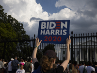 A person is showing a sign with the words ''Biden Harris 2020'' in front of the White House in Washington, DC, USA, on July 21, 2024. The da...