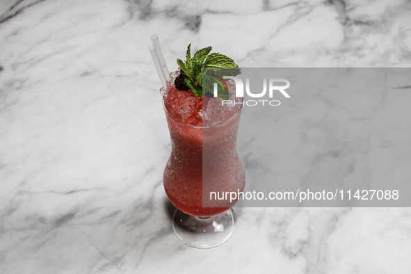 The cocktail ''Golden Medalist'' is sitting on a bright background. 