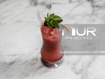 The cocktail ''Golden Medalist'' is sitting on a bright background. (