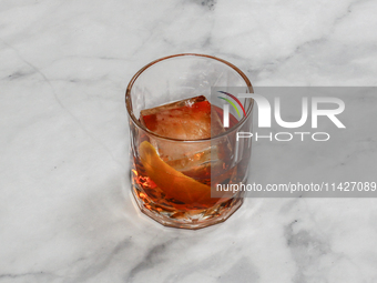 A cocktail ''Negroni'' is sitting on a bright background. (