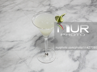 A cocktail ''Gimlet'' is sitting on a bright background. (