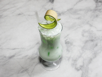 A cocktail ''Melon Lounge'' is appearing on a bright background. (