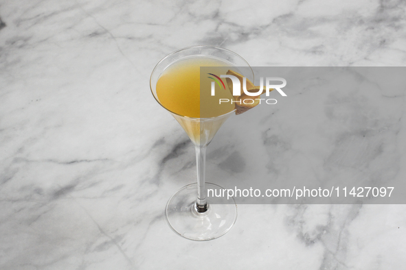 A cocktail ''Sidecar'' is sitting on a bright background. 