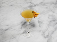 A cocktail ''Sidecar'' is sitting on a bright background. (