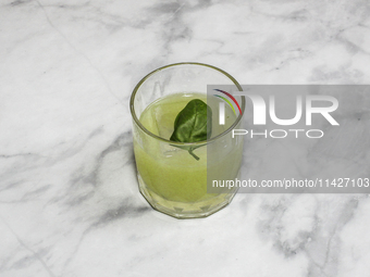 A cocktail ''Gin Basil Smash'' is sitting on a bright background. (