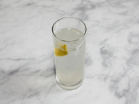 A cocktail ''Gin Fizz'' is sitting on a bright background. (