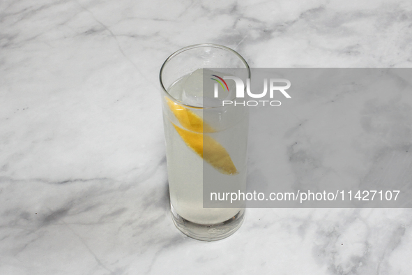 A cocktail ''Oriental Melon High Ball'' is sitting on a bright background. 