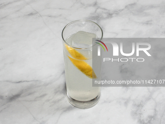 A cocktail ''Oriental Melon High Ball'' is sitting on a bright background. (