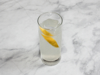 A cocktail ''Oriental Melon High Ball'' is sitting on a bright background. (