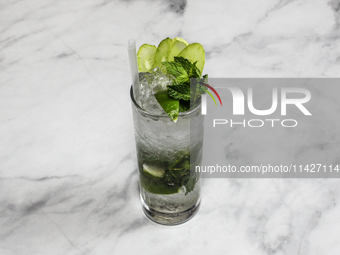 A cocktail ''Handrix Mojito'' is sitting on a bright background. (