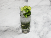 A cocktail ''Handrix Mojito'' is sitting on a bright background. (