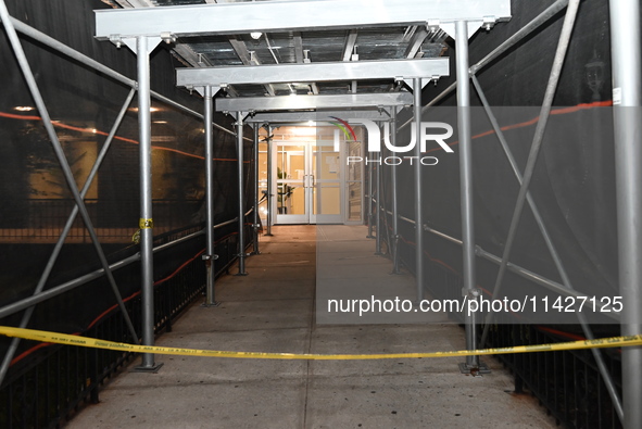 Police tape is blocking the entrance to the building. A man is being shot in the head and killed in Bronx, New York, United States, on July...