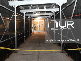 Police tape is blocking the entrance to the building. A man is being shot in the head and killed in Bronx, New York, United States, on July...