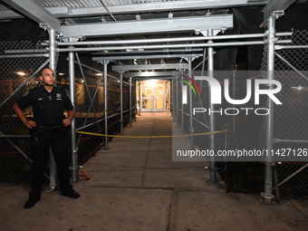 A police officer is guarding the crime scene. A man is being shot in the head and killed in Bronx, New York, United States, on July 21, 2024...