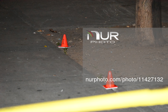 Evidence cones are at the scene. A male is in critical condition after being shot in an apartment building in Bronx, New York, United States...