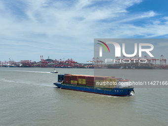 A large container ship is leaving the dock at Yangshan Port in Shanghai, China, on July 21, 2024. (