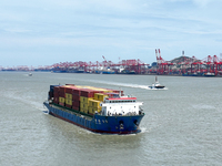 A large container ship is leaving the dock at Yangshan Port in Shanghai, China, on July 21, 2024. (