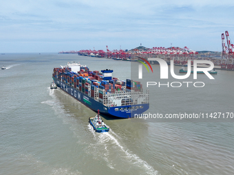 Large container ships are traveling to and from Yangshan Port in Shanghai, China, on July 21, 2024. (