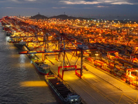 A photo is showing the working scene at the wharf of Shanghai Yangshan Port in Shanghai, China, on July 21, 2024, in the evening. (