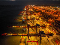 A photo is showing the working scene at the wharf of Shanghai Yangshan Port in Shanghai, China, on July 21, 2024, in the evening. (