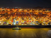 A photo is showing the working scene at the wharf of Shanghai Yangshan Port in Shanghai, China, on July 21, 2024, in the evening. (