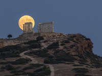 The Full Buck Moon rises behind the ancient Greek Temple of Poseidon on Cape Sounion in Greece on July 20, 2024 (