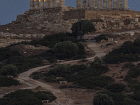 The Full Buck Moon rises behind the ancient Greek Temple of Poseidon on Cape Sounion in Greece on July 20, 2024 (