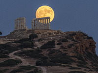 The Full Buck Moon rises behind the ancient Greek Temple of Poseidon on Cape Sounion in Greece on July 20, 2024 (