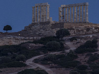 The Full Buck Moon rises behind the ancient Greek Temple of Poseidon on Cape Sounion in Greece on July 20, 2024 (