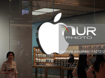 Customers are trying on and learning about Apple Vision Pro headsets at an Apple store in Shanghai, China, on July 22, 2024. (