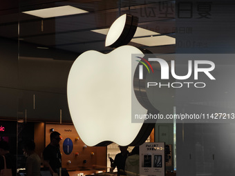 Customers are trying on and learning about Apple Vision Pro headsets at an Apple store in Shanghai, China, on July 22, 2024. (