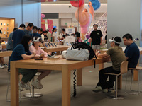 Customers are trying on and learning about Apple Vision Pro headsets at an Apple store in Shanghai, China, on July 22, 2024. (