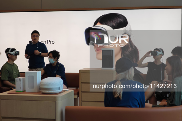 Customers are trying on and learning about Apple Vision Pro headsets at an Apple store in Shanghai, China, on July 22, 2024. 