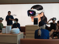 Customers are trying on and learning about Apple Vision Pro headsets at an Apple store in Shanghai, China, on July 22, 2024. (