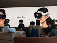 Customers are trying on and learning about Apple Vision Pro headsets at an Apple store in Shanghai, China, on July 22, 2024. (