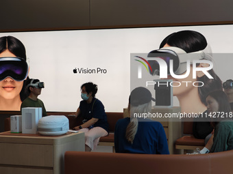 Customers are trying on and learning about Apple Vision Pro headsets at an Apple store in Shanghai, China, on July 22, 2024. (