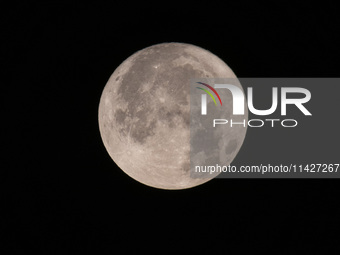 Close up of  the Full Moon of July 2024 known as Buck Moon or Thunder Moon spotted over Mount Olympus in Greece. Mount Olympus is a National...